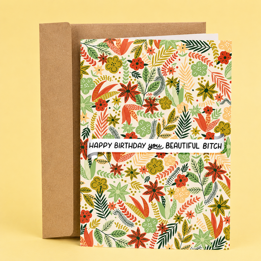 Sleazy Greetings funny birthday card featuring a colorful floral pattern filled with illustrated flowers and leaves, with a banner across the center that reads “Happy Birthday You Beautiful Bitch,” paired with a kraft envelope.