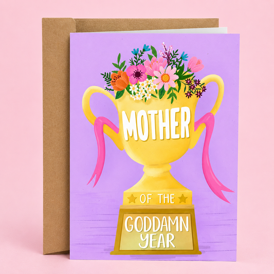 Sleazy Greetings funny Mother’s Day card featuring a gold trophy overflowing with colorful flowers on a purple background with the message “Mother Of The Goddamn Year,” paired with a kraft envelope.