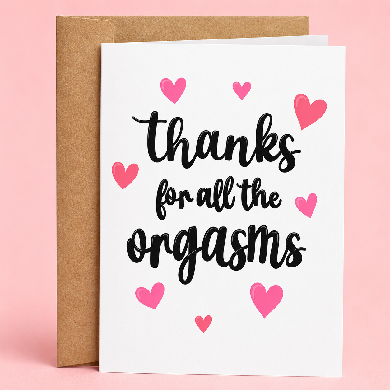 Sleazy Greetings funny romantic and anniversary greeting card featuring black script lettering that reads “Thanks For All The Orgasms” surrounded by pink hearts on a white background, paired with a kraft envelope.