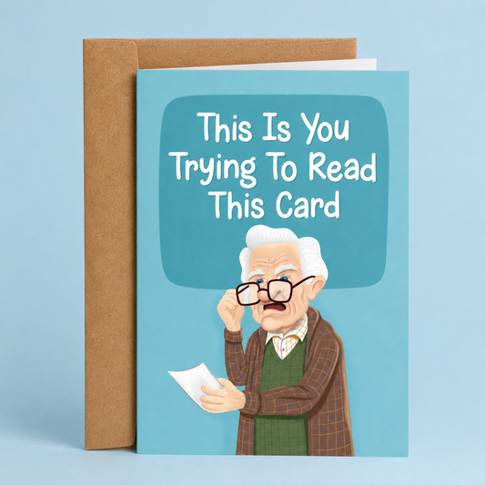 Sleazy Greetings funny birthday card featuring an elderly man squinting through his glasses while reading a paper on a blue background with the joke “This Is You Trying To Read This Card,” paired with a kraft envelope.