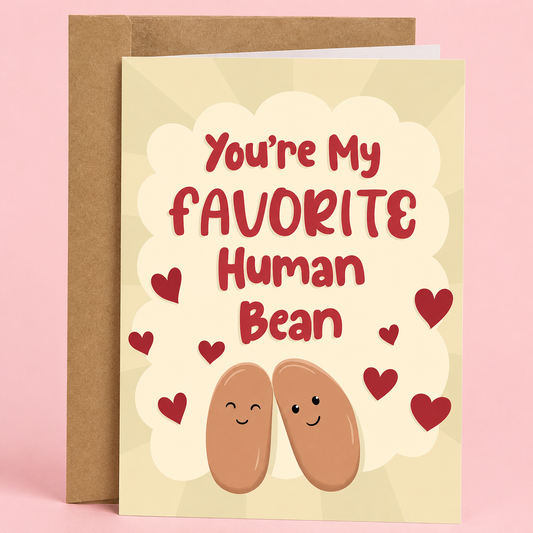 Sleazy Greetings cute love and anniversary greeting card featuring two smiling beans surrounded by red hearts on a cream background with the pun “You’re My Favorite Human Bean,” paired with a kraft envelope.