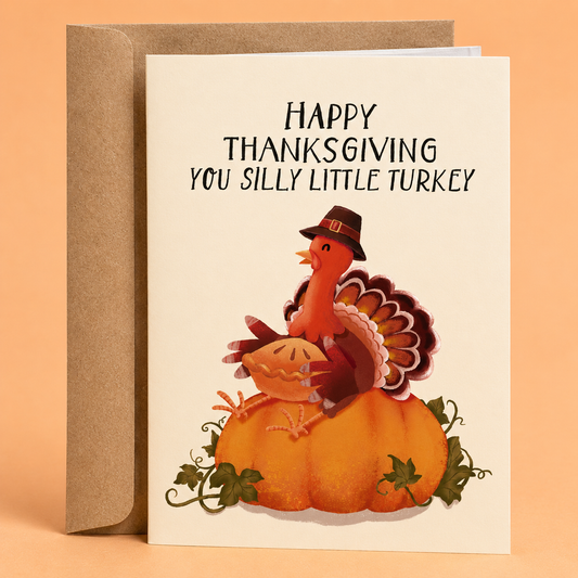 Sleazy Greetings funny Thanksgiving card featuring an adorable turkey wearing a pilgrim hat while sitting on a pumpkin and holding a pie, paired with the message “Happy Thanksgiving You Silly Little Turkey.” A cute and lighthearted Thanksgiving greeting card perfect for friends, family, coworkers, hosts, and anyone who enjoys wholesome seasonal humor and festive fall illustrations.