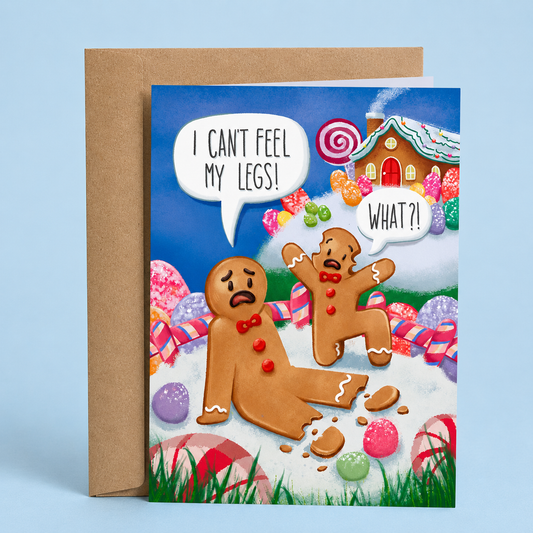 Sleazy Greetings funny Christmas card featuring gingerbread cookie dark humor with “I Can’t Feel My Legs!” joke, candy land holiday illustration, and playful twisted Christmas comedy on premium matte cardstock with kraft envelope.