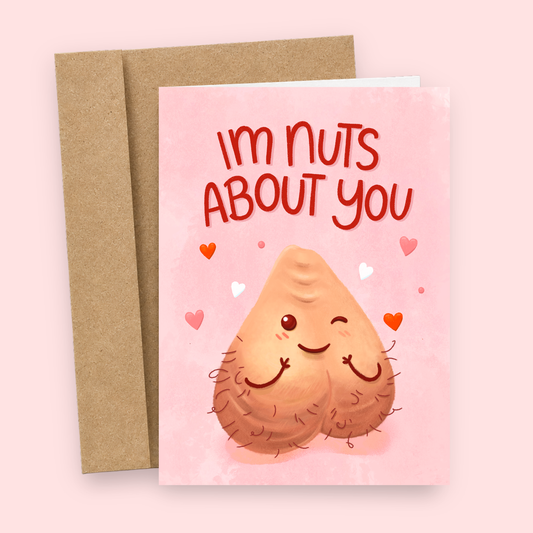 Sleazy Greetings funny love or Valentine’s Day card featuring “I’m Nuts About You” humor with adorable anthropomorphic hairy balls illustration, cheeky romantic comedy, and cute inappropriate pun design on premium matte cardstock with kraft envelope.