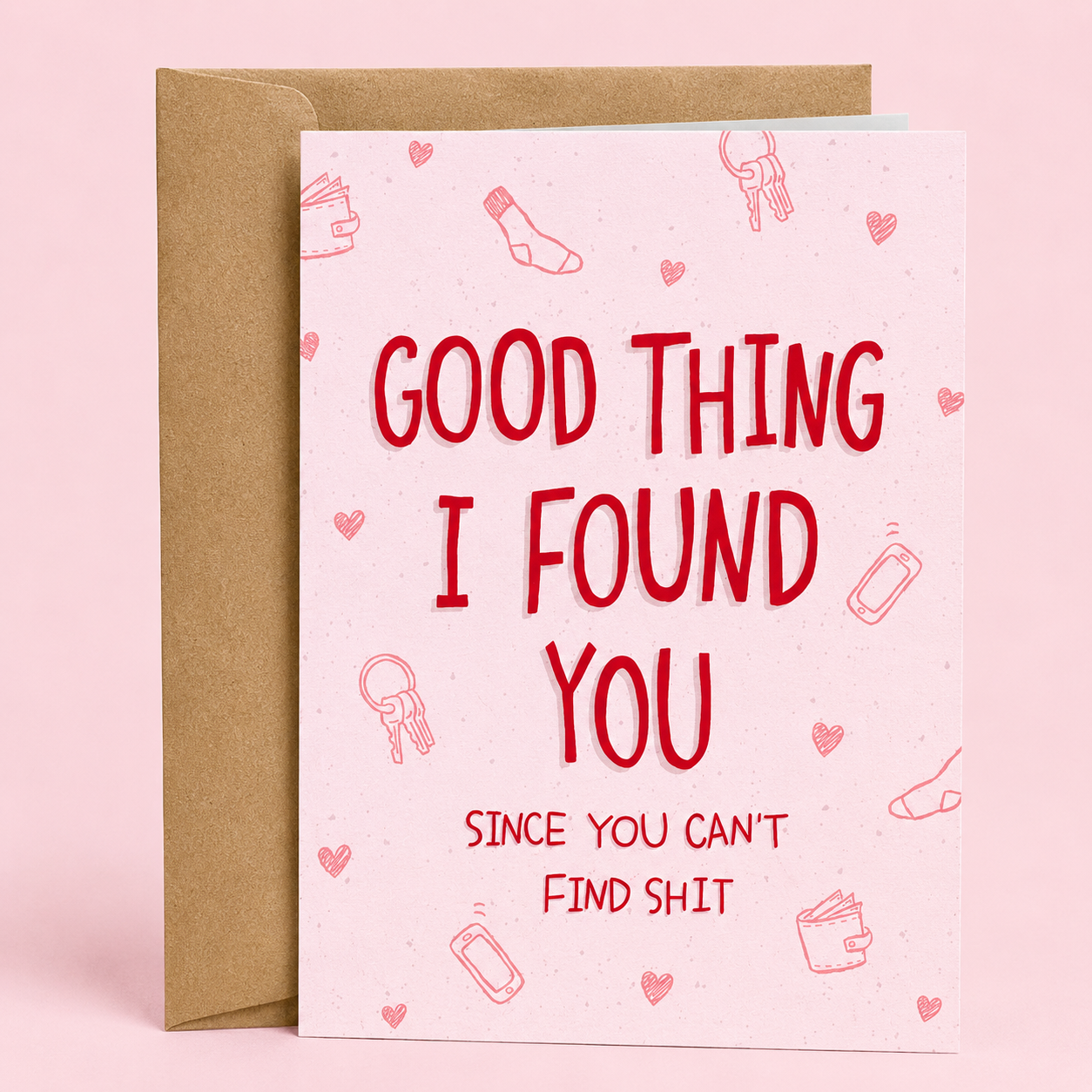 Sleazy Greetings funny love or anniversary card featuring “Good Thing I Found You Since You Can’t Find Shit” humor with minimalist pink typography design, relatable relationship comedy, and cute everyday item doodles on premium matte cardstock with kraft envelope.