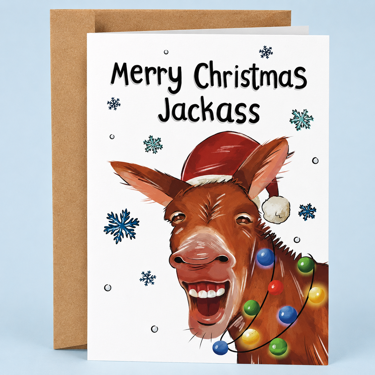 Sleazy Greetings funny Christmas card featuring “Merry Christmas Jackass” humor with festive donkey illustration, Santa hat, and Christmas lights on premium matte cardstock with kraft envelope.