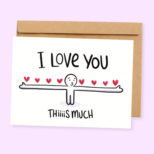 A greeting card with a cartoon illustration of a character saying 'I love you this much' surrounded by hearts, with the text 'This is much' on the bottom right. The card has a light background and is paired with a beige kraft envelope.