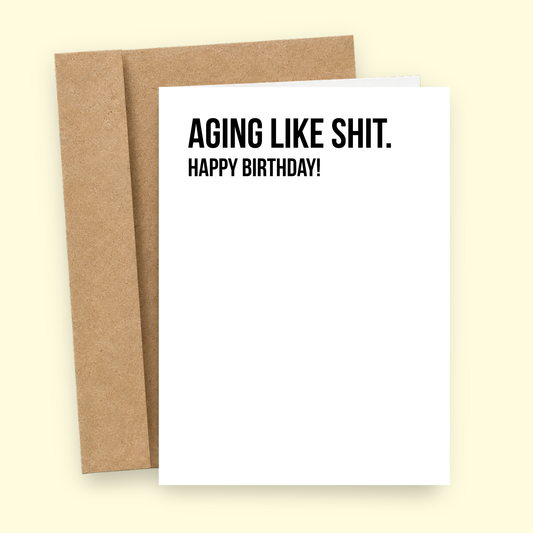 Sleazy Greetings funny birthday card featuring minimalist bold typography that says ‘Aging Like Shit. Happy Birthday!’ Brutally honest birthday card with dry sarcastic humor, clean minimalist design, and aggressively deteriorating gremlin energy.