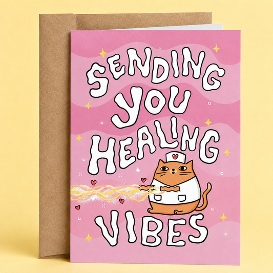Greeting card with a cat illustration and text 'Sending you healing vibes' on a pink background.