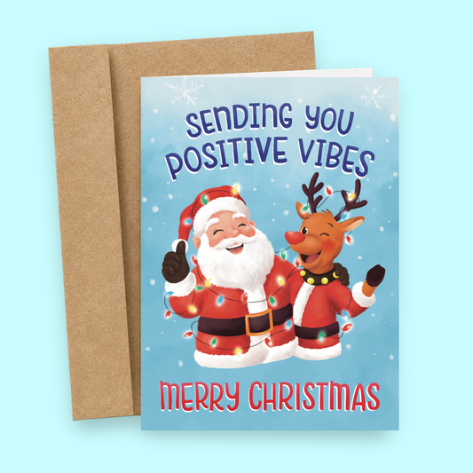 Sleazy Greetings funny Christmas card featuring Santa and Rudolph wrapped in colorful holiday lights beside the phrase ‘Sending You Positive Vibes, Merry Christmas.’ Cute festive greeting card with wholesome holiday energy, playful winter artwork, and cheerful cozy vibes.