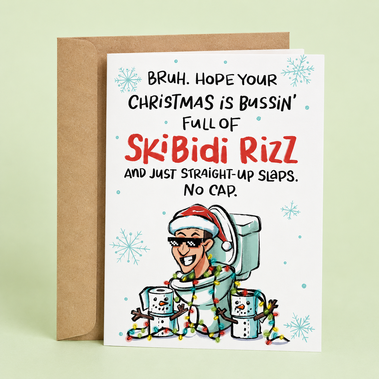 Sleazy Greetings funny Christmas card featuring the phrase ‘Hope Your Christmas Is Bussin’ Full Of Skibidi Rizz’ with a meme-inspired toilet character in a Santa hat surrounded by Christmas lights and toilet paper snowmen. Humorous Gen Z holiday card with kraft envelope included.