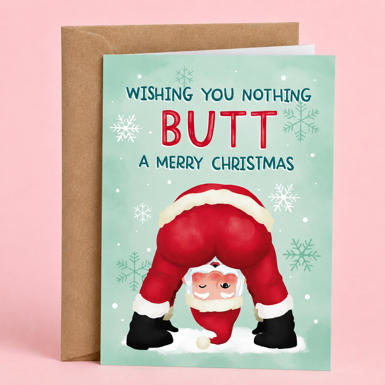 Sleazy Greetings funny Christmas card featuring the phrase ‘Wishing You Nothing Butt A Merry Christmas’ with a humorous upside-down Santa illustration showing a rounded backside. Playful holiday greeting card with snowflake accents, pastel winter colors, and a kraft envelope included.