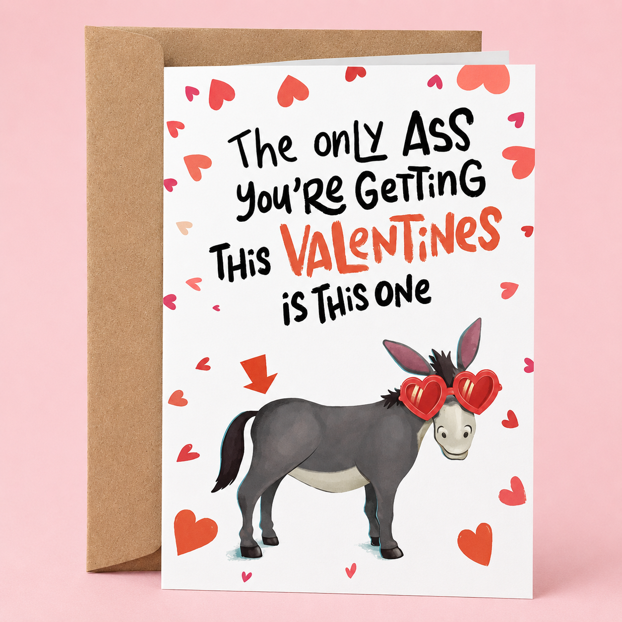 Sleazy Greetings funny Valentine’s Day card featuring the phrase ‘The Only Ass You’re Getting This Valentines Is This One’ with a humorous donkey illustration wearing heart-shaped sunglasses and an arrow pointing at its backside. Sarcastic romantic greeting card with heart accents and a kraft envelope included.