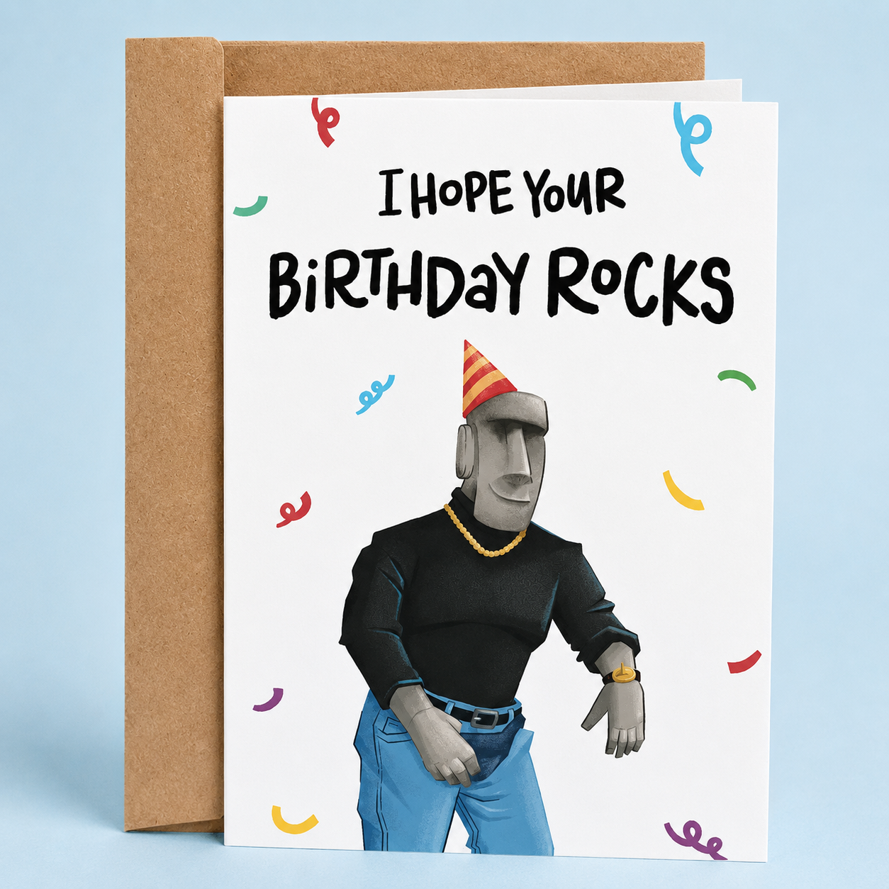 Sleazy Greetings funny birthday card featuring the phrase ‘I Hope Your Birthday Rocks’ with a humorous illustration of a Moai Easter Island statue wearing a party hat, jeans, jewelry, and a black shirt. Silly pun birthday greeting card with colorful confetti accents and a kraft envelope included.