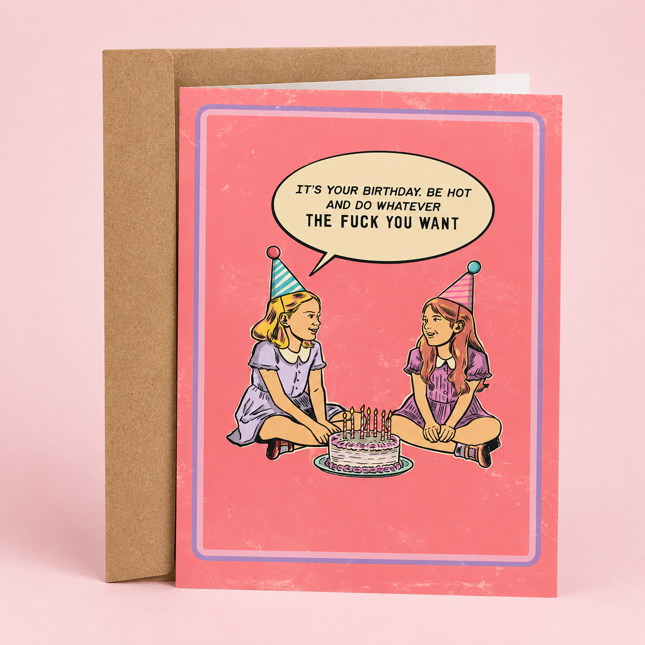 Sleazy Greetings funny birthday card featuring a retro-style illustration of two girls wearing party hats sitting beside a birthday cake with bold humorous dialogue. The vintage-inspired pink card design includes the phrase ‘It’s your birthday. Be hot and do whatever the fuck you want.’ Displayed as a premium folded Sleazy Greetings card with kraft envelope.