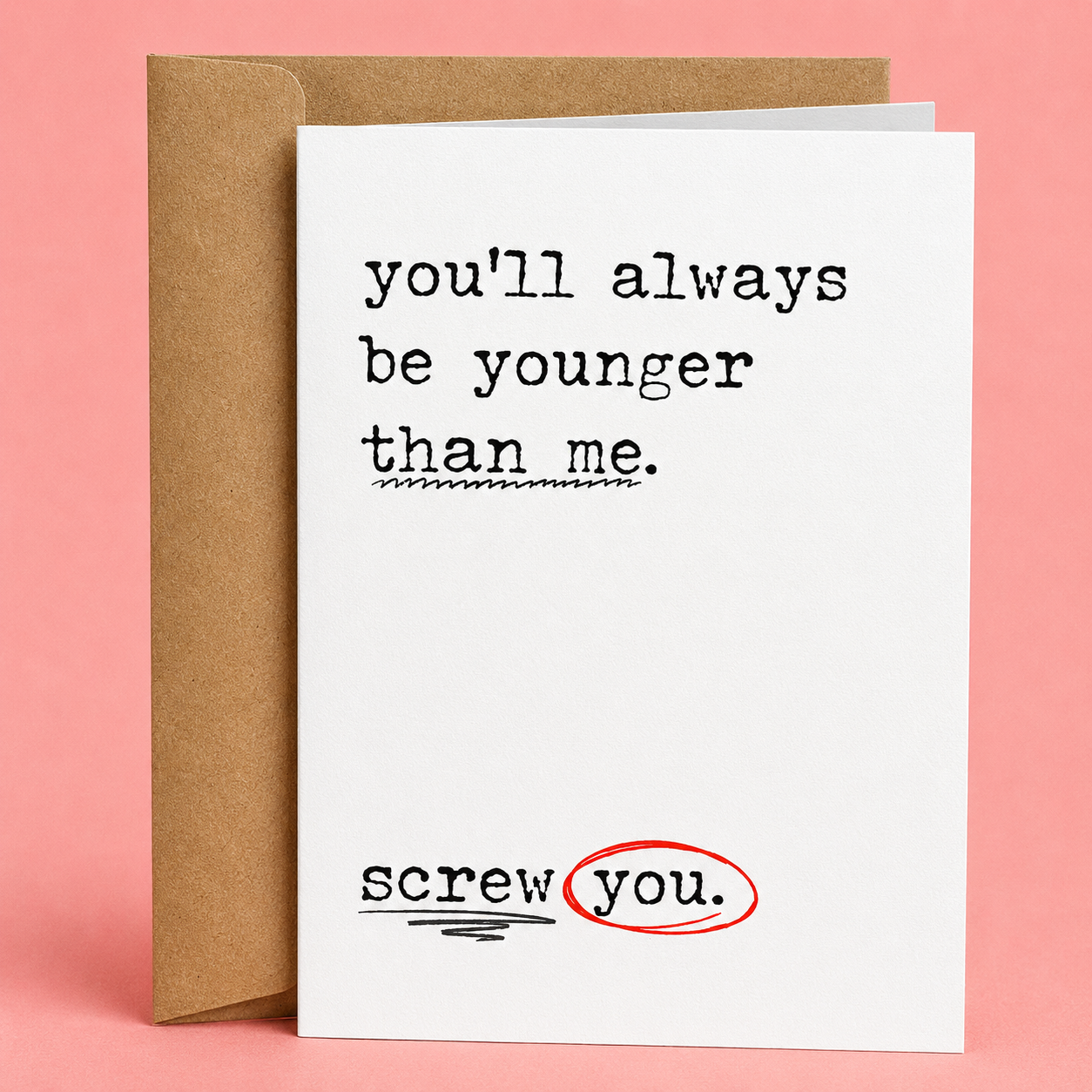 Sleazy Greetings funny birthday card featuring the sarcastic message ‘you’ll always be younger than me.’ followed by ‘screw you.’ with red circled markup details for a humorous passive-aggressive design. Displayed as a premium white folded Sleazy Greetings card with kraft envelope.