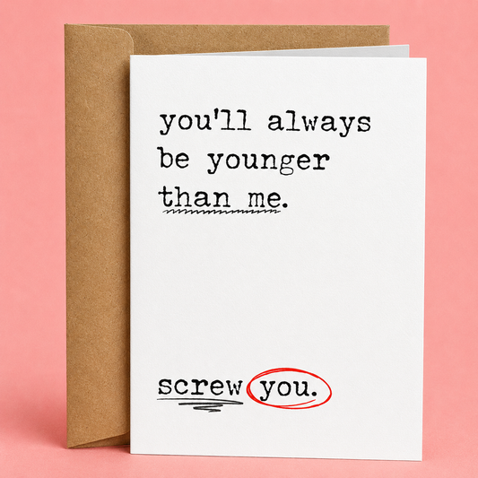 Sleazy Greetings funny birthday card featuring the sarcastic message ‘you’ll always be younger than me.’ followed by ‘screw you.’ with red circled markup details for a humorous passive-aggressive design. Displayed as a premium white folded Sleazy Greetings card with kraft envelope.