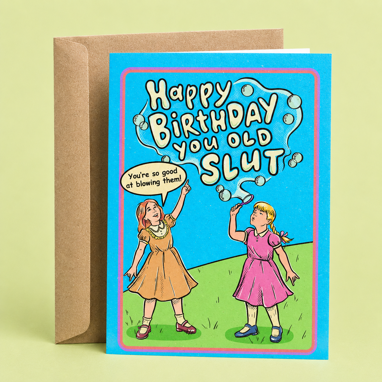 Sleazy Greetings funny birthday card featuring two vintage-style girls blowing bubbles on a bright blue background, with the cheeky message “Happy Birthday You Old Slut” and the joke “You’re So Good at Blowing Them!” paired with a kraft envelope.