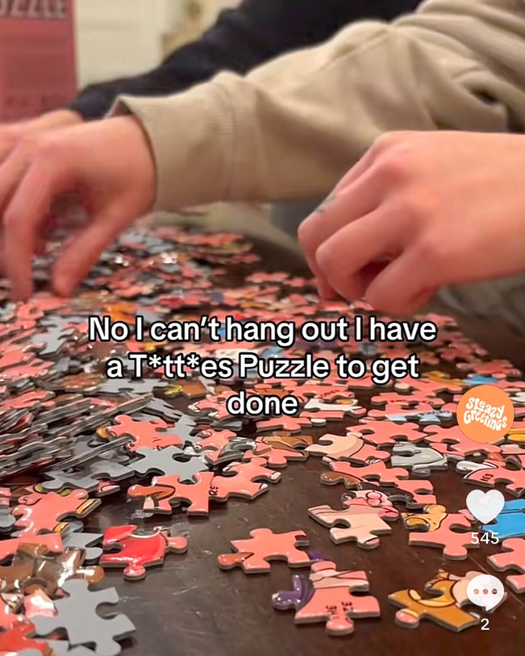 Group working on the raunchy Tits a Puzzle jigsaw puzzle, a humorous adult party puzzle.