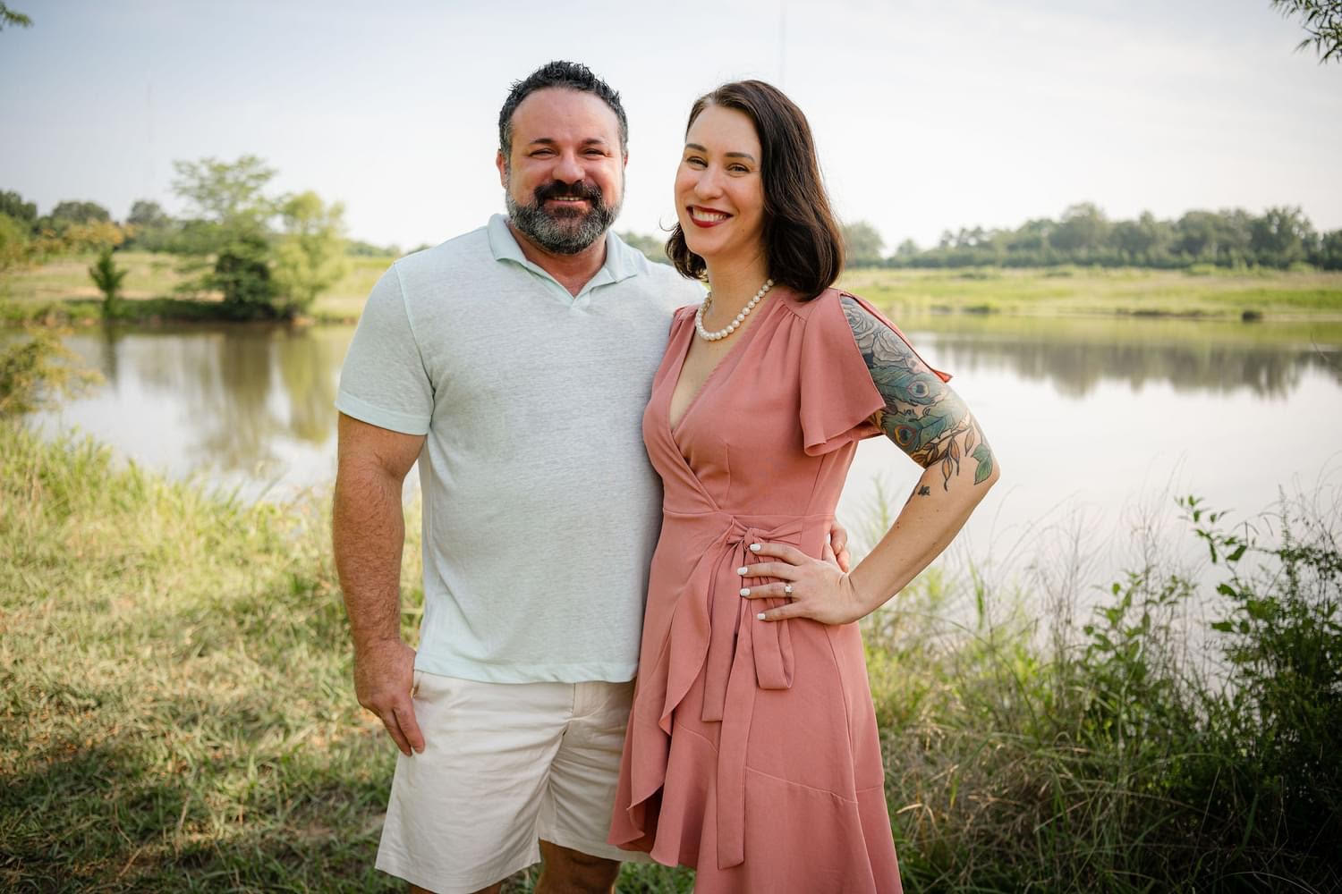 Tara and Brian Bal posing together outside of a pond.